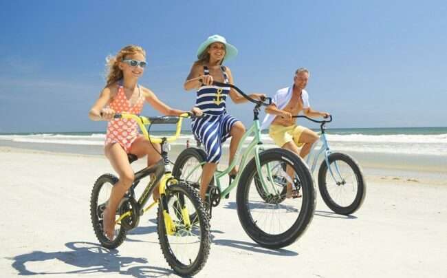 Biking the beach as the featured image for VEEGO Fat Tire - The Best Affordable All Terrain E-Bike post.