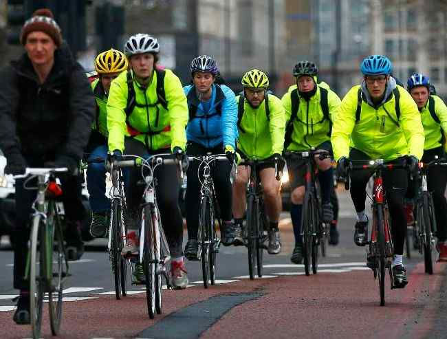 A group of city workers cycling to work in a winter morning.