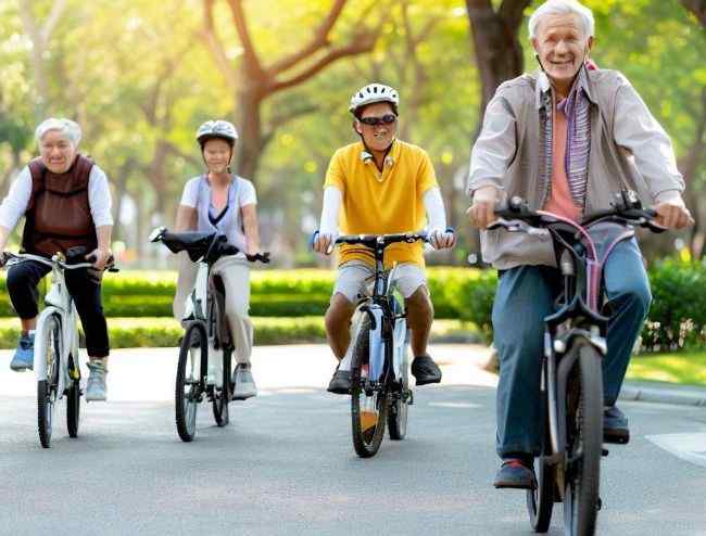 A seniors group cycling electric bikes in the park for workouts.